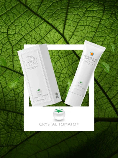 Crystal Tomato skin clarity cream and SPF 79 sunscreen on a green leaf background